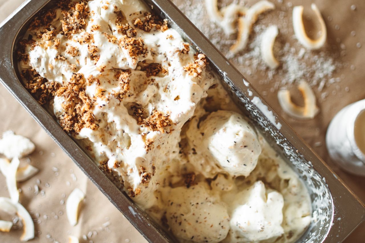 A tempting close-up of creamy ice cream topped with crunchy crumbs, perfect for dessert lovers.