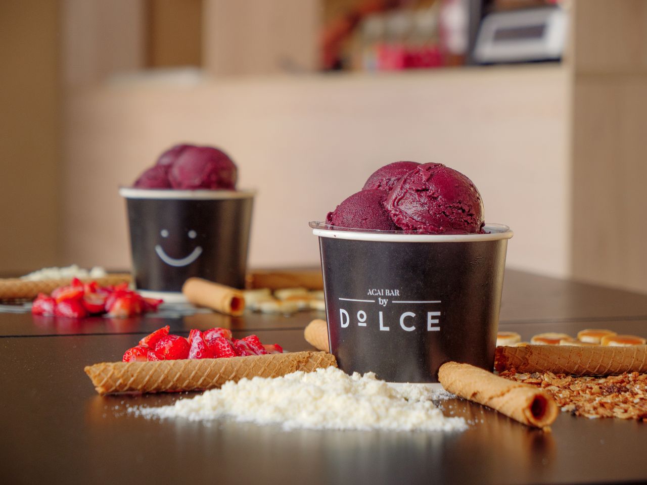 Close-up of a delicious acai bowl with various toppings including fruits and wafers.