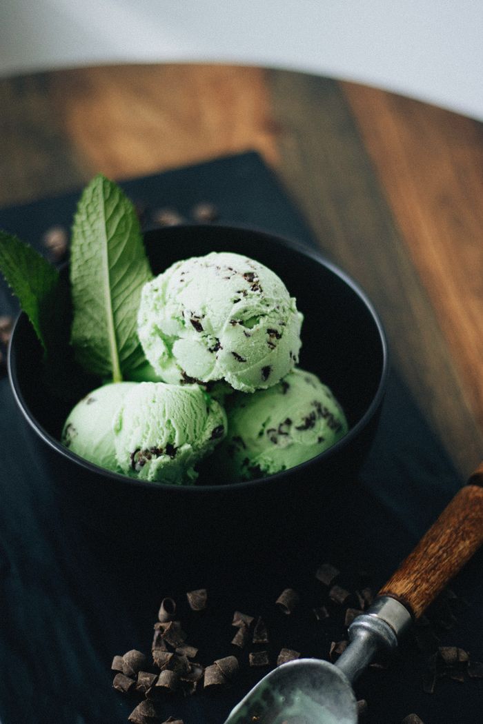 About Artisan mint chocolate chip ice cream with fresh mint leaves, perfect for dessert photography.